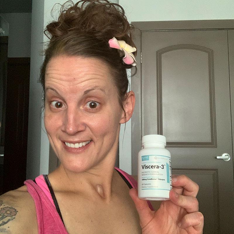 Smiling women in kitchen holding one bottle of product Viscera-3