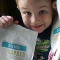 Little boy holding two products