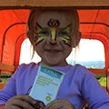 Cute girl having cat makeup with sane product