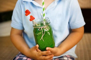 Child Holding Green Smoothie